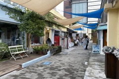 More shops with blue and white parasails